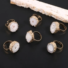 Detail of adjustable gold ring featuring 925 stamp and natural white druzy crystal stone