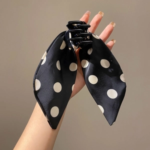 Black hair claw clip with black and white polka dot ribbon bow accessory for women