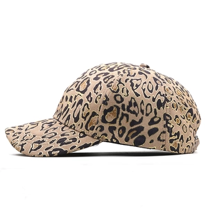 Detail view of stylish leopard print baseball cap with gold trim and velvet texture