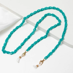 Detailed shot of teal acrylic chain links with gold clasps and rubber loops for glasses