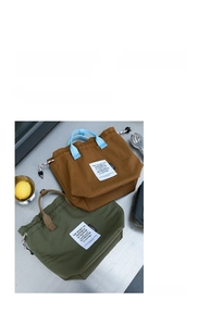 Detail of insulated drawstring lunch bags in olive and brown with durable nylon texture