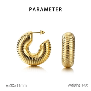 Detailed view of ribbed C-shaped hollow hoop earrings in gold stainless steel finish