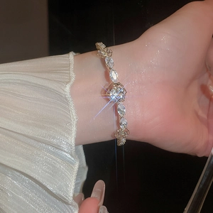 Close-up of 14k gold plated flower bracelet with marquise zircons on woman's wrist