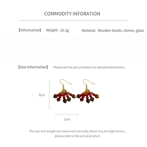 Detail view of bohemian wood bead and glass tassel earrings with size dimensions and weight