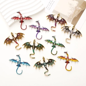 Dragon enamel pins set with rhinestones in multiple colors on a white background