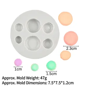 Detail of 6-cavity macaron silicone mold showing different sizes from 1cm to 2.3cm