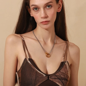 Minimalist double ring pendant necklace in 18K gold and silver plating on professional model
