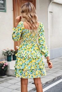 Detail view of the floral dress back featuring elastic smocked bodice and tiered ruffled hem