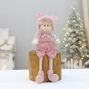 Pink plush Christmas reindeer doll with long legs on a rustic wood stand decoration