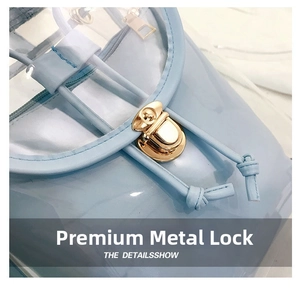 Detail of light blue transparent PVC backpack with golden metal twist lock and drawstring