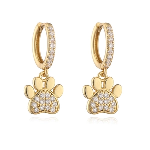 Detailed close-up of golden paw print earrings with sparkling white crystals