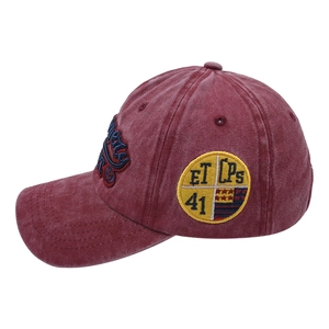 Detailed close-up of vintage washed baseball cap with yellow circular embroidery patch