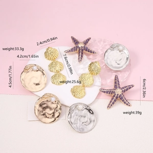 Detailed view of coastal jewelry collection with shell, starfish and pearl pendant sizes