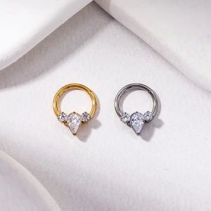 Detail view of gold and silver G23 titanium rings set with sparkling zircon crystals