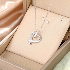 Elegant heart pendant necklace with white zircons in a champagne velvet jewelry box