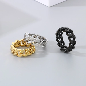 Detailed shot of punk style cuban link rings in gold silver and black titanium steel