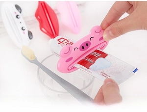 Close-up of cute cartoon pig tube squeezer for toothpaste and skincare products