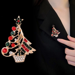 Fashionable gold-plated Christmas tree brooch with colorful rhinestones on a blazer