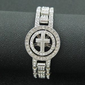 Detail view of silver hip-hop bracelet with iced-out cross design and studded rhinestones