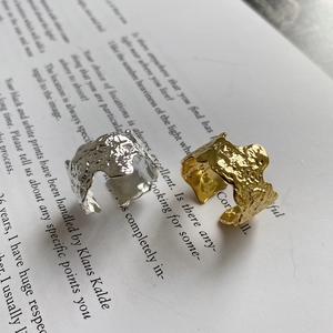 Macro detail of irregular pleated texture on S925 sterling silver rings with S925 stamp