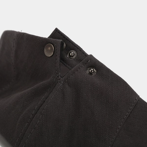 Detail view of high-quality twill cotton fabric with three bronze metal snap buttons