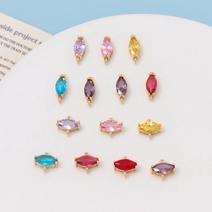 Macro detail of colorful marquise cubic zirconia pendants with gold-plated connectors