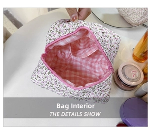 Detail view of floral cotton makeup bag interior with pink checkered lining and pocket