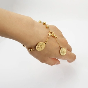 Gold stainless steel religious bracelet with Saint Benedict charms and cross for women