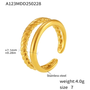 Detail of double-layer gold stainless steel ring with twisted and smooth texture bands