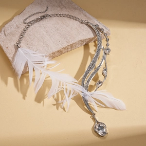 Asymmetric silver feather necklace with sparkling crystals and a large teardrop gemstone