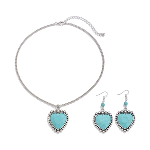 Detail of vintage heart jewelry set with turquoise inlay and silver necklaces