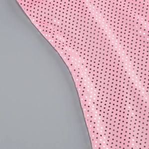 Macro detail of pink fabric with silver sequins and metallic texture on a long dress