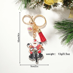 Santa Claus riding a motorcycle keychain with red tassel and colorful sequin ball charm