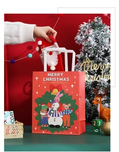 Detailed view of red Christmas gift bags with cartoon snowmen and animals on festive background