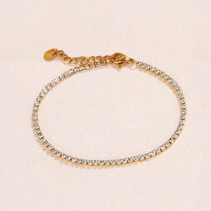 Detail view of gold stainless steel tennis bracelet with zircon stones and extender chain