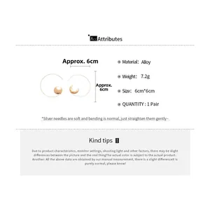 Detail specifications for asymmetrical gold hoop earrings with moon and disc charms