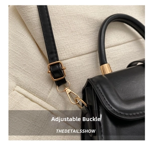 Detailed shot of the black leather saddle bag featuring premium gold hardware and adjustable strap