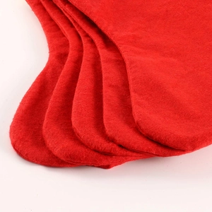 Classic red felt Christmas stockings with white cuffs stacked on a clean white background