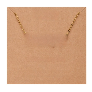 Detailed shot of 18k gold plated stainless steel Scorpio necklace on a kraft card