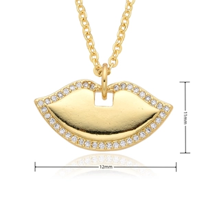 Macro shot of gold-finished lip pendant with micro-inlays measuring 11mm by 12mm