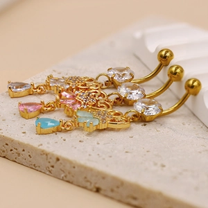 Detailed view of hollow heart belly rings with zircon water drop charms in three colors