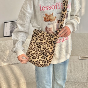 Close-up of leopard print faux fur texture and wide shoulder strap on crossbody bag
