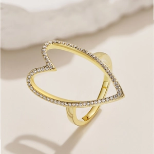 Macro detail of gold plated S925 silver ring featuring hollow heart design with pavé zircons