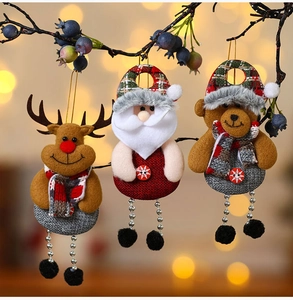 Charming fabric Santa, reindeer, and bear ornaments hanging on a rustic berry branch