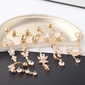 Golden belly piercing set with zircon stones in heart, flower, and butterfly shapes