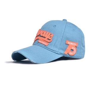 Close-up of distressed brim and 3D embroidery on blue washed cotton baseball cap