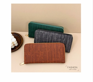 Detailed stack of striped long wallets in dark green, grey, and tan with gold zippers