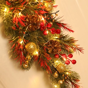Christmas hanging decoration with pine cones, red berries, gold balls and LED lights