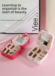 Close-up of portable PU leather jewelry box featuring built-in mirror and ring slots