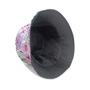 Reversible bucket hat with pink peony flower print and black interior for sun protection